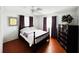 Bedroom with a queen bed, ceiling fan, and dark wood dresser at 9031 Hilolo Ln, Venice, FL 34293