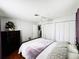 Bedroom featuring a queen bed, floral arrangement and dark wood dresser at 9031 Hilolo Ln, Venice, FL 34293