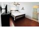 Bright bedroom with a bed, ceiling fan, modern decor, and a bathroom entrance at 9031 Hilolo Ln, Venice, FL 34293