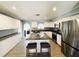 Modern kitchen featuring white cabinets, stainless steel appliances, granite countertops, and a central island at 9031 Hilolo Ln, Venice, FL 34293