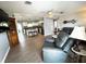 Comfortable living room with wood floors, a kitchen view with stainless steel appliances, and cozy seating at 9031 Hilolo Ln, Venice, FL 34293
