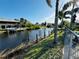 Picturesque waterfront view showcasing a canal with docks and tropical foliage at 9031 Hilolo Ln, Venice, FL 34293