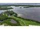 Aerial view of a waterfront community featuring lush green spaces, winding paths, and serene lakes at 9414 Andover Cir, Bradenton, FL 34210