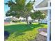 Large backyard with shade tree, plus community amenities in the distance at 9414 Andover Cir, Bradenton, FL 34210