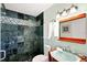 Bathroom featuring a modern vanity, walk-in shower with dark tiling, and stylish fixtures at 9414 Andover Cir, Bradenton, FL 34210