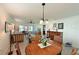 Dining area with a wooden table and chairs adjacent to a bright and airy living room at 9414 Andover Cir, Bradenton, FL 34210