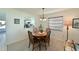 Dining area with a view of the kitchen, featuring a wooden table and comfortable seating at 9414 Andover Cir, Bradenton, FL 34210