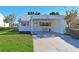 Charming single-story home with a carport, bright pink shutters, and well-maintained landscaping at 9414 Andover Cir, Bradenton, FL 34210