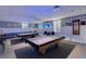 Well-lit game room showcases two billiard tables, comfortable seating, and nautical-themed decorations for entertainment at 9414 Andover Cir, Bradenton, FL 34210