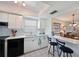 Bright white kitchen featuring a pass-through to the dining area and bar stool seating at 9414 Andover Cir, Bradenton, FL 34210