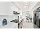 Clean white kitchen featuring tiled backsplash and pass-through to dining area at 9414 Andover Cir, Bradenton, FL 34210