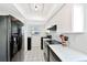 Well-lit kitchen featuring white cabinets, tiled floors, and stainless-steel appliances at 9414 Andover Cir, Bradenton, FL 34210