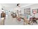Open living room featuring tiled floors, a large window, and easy access to the dining area at 9414 Andover Cir, Bradenton, FL 34210