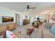 Bright living room featuring wood-look tile floors, ceiling fan, and comfortable furnishings at 9414 Andover Cir, Bradenton, FL 34210