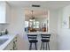 Pass through from the kitchen to the dining room with bar stool seating and view to living room at 9414 Andover Cir, Bradenton, FL 34210