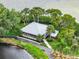 Aerial view of a covered pavilion with picnic tables surrounded by lush greenery and a tranquil lake at 9414 Andover Cir, Bradenton, FL 34210