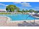 Inviting community pool with ample lounge chairs and lush landscaping, perfect for relaxation and social gatherings at 9414 Andover Cir, Bradenton, FL 34210