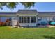 View of the backyard and enclosed sunroom at 3807 41St Street W Ct # 52, Bradenton, FL 34205