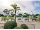 Outdoor bocce ball court framed by palm trees, benches, and blue skies at 3807 41St Street W Ct # 52, Bradenton, FL 34205