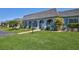 Inviting home featuring a lush lawn, paved walkway, and covered porch, perfect for enjoying outdoor living at 3807 41St Street W Ct # 52, Bradenton, FL 34205