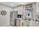 Modern kitchen featuring stainless steel appliances, white cabinets, and elegant countertops at 3807 41St Street W Ct # 52, Bradenton, FL 34205