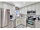 Well-equipped kitchen boasts stainless steel appliances, white cabinets, and elegant countertops at 3807 41St Street W Ct # 52, Bradenton, FL 34205