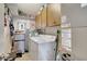 Functional laundry room with washer, dryer, storage cabinets, and mini-fridge at 3807 41St Street W Ct # 52, Bradenton, FL 34205