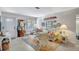 Inviting living room featuring a striped sofa, colorful rug, wicker chairs, and charming decor at 3807 41St Street W Ct # 52, Bradenton, FL 34205