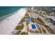 Stunning aerial view capturing a vibrant beach scene with a pool, coastal buildings, and turquoise waters at 1001 Benjamin Franklin Dr # 511, Sarasota, FL 34236
