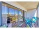 Enjoy this relaxing balcony with beautiful blue outdoor furniture and scenic views through large sliding glass doors at 1001 Benjamin Franklin Dr # 511, Sarasota, FL 34236