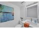 Bathroom features modern vanity, stylish art, and plenty of natural light at 1001 Benjamin Franklin Dr # 511, Sarasota, FL 34236