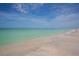 Scenic shoreline showing clear blue water meeting the sandy beach at 1001 Benjamin Franklin Dr # 511, Sarasota, FL 34236