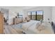 Bright bedroom featuring a large window, dresser, and relaxing seating at 1001 Benjamin Franklin Dr # 511, Sarasota, FL 34236