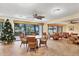 Inviting common room area featuring tables, chairs and access to the outdoors at 1001 Benjamin Franklin Dr # 511, Sarasota, FL 34236