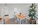 Bright dining room featuring a pass through to the kitchen, a large window and stylish decor at 1001 Benjamin Franklin Dr # 511, Sarasota, FL 34236