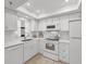 The updated white kitchen features modern appliances and ample natural light at 1001 Benjamin Franklin Dr # 511, Sarasota, FL 34236
