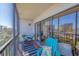 Cozy screened-in patio with seating area and sliding glass doors at 1001 Benjamin Franklin Dr # 511, Sarasota, FL 34236