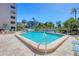 Enjoy the large pool surrounded by palm trees and seating, perfect for relaxing and soaking up the sun at 1001 Benjamin Franklin Dr # 511, Sarasota, FL 34236