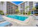 Relax by the large pool surrounded by comfortable seating and lush tropical greenery at 1001 Benjamin Franklin Dr # 511, Sarasota, FL 34236