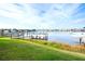 Backyard view featuring a well-maintained lawn and dock with a boat lift at 1022 Overlook Ct, Bradenton, FL 34208