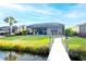 Backyard view featuring a well-maintained lawn and private dock access at 1022 Overlook Ct, Bradenton, FL 34208