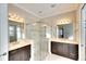 Bathroom featuring double sinks, walk-in shower with glass door and tiled surround at 1022 Overlook Ct, Bradenton, FL 34208