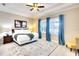 Bedroom featuring tray ceilings, ample natural light, stylish decor, and ceiling fan at 1022 Overlook Ct, Bradenton, FL 34208