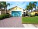 Charming home with a blue garage door and a neatly landscaped front yard at 1022 Overlook Ct, Bradenton, FL 34208