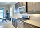 Updated kitchen with granite countertops, stainless appliances, and a stylish tile backsplash at 1022 Overlook Ct, Bradenton, FL 34208