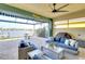 Inviting covered lanai with comfortable seating, ceiling fan, and views of the waterway at 1022 Overlook Ct, Bradenton, FL 34208