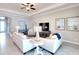 Comfortable living room with tile flooring, tray ceiling, and views of the outdoor area at 1022 Overlook Ct, Bradenton, FL 34208