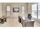 Bright office space with desk, neutral walls, plantation shutters, and tiled floors at 1022 Overlook Ct, Bradenton, FL 34208