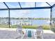 Relaxing waterfront view from the lanai with comfortable seating and a boat dock at 1022 Overlook Ct, Bradenton, FL 34208