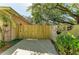 A wooden gate and concrete pathway lead to the home's side yard at 1122 133Rd E St, Bradenton, FL 34212